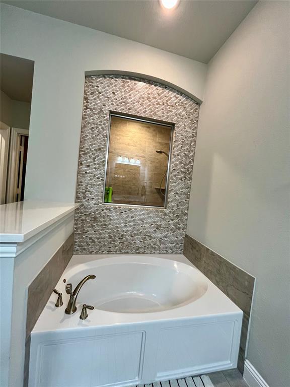 7040 Cross Point Lane Little Elm, TX 76227 - Photo 9 of 16 a bathroom with a bathtub