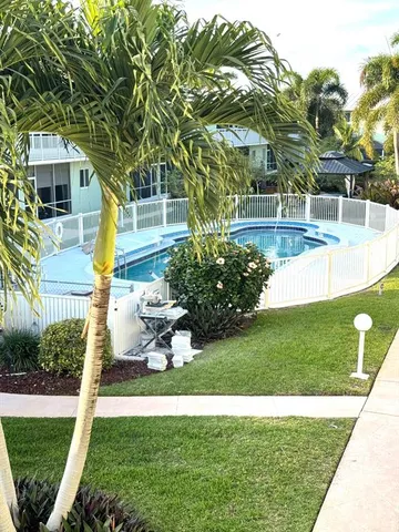 a backyard of a house with lots of green space and fountain