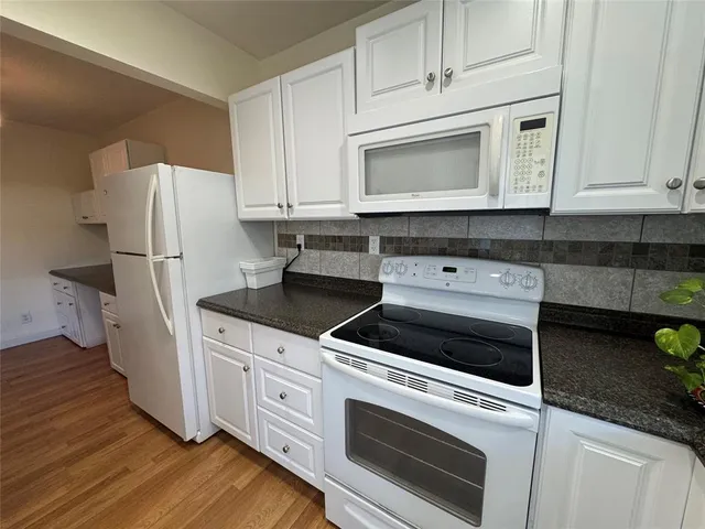 a kitchen with sink cabinets and window