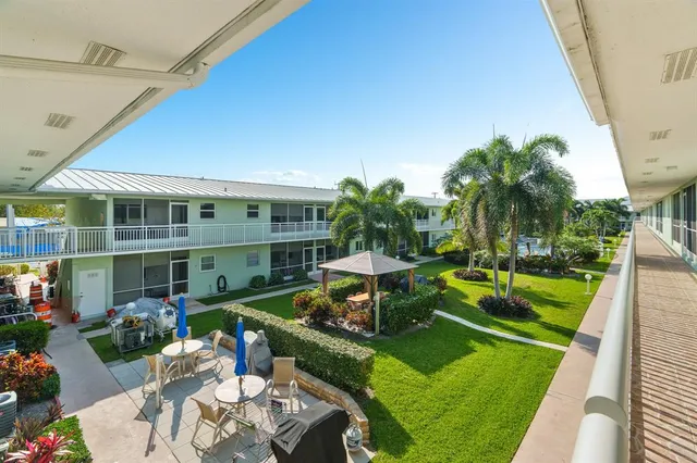 a view of an house with backyard porch and garden