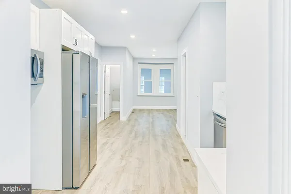 a view of a kitchen with a refrigerator and a window