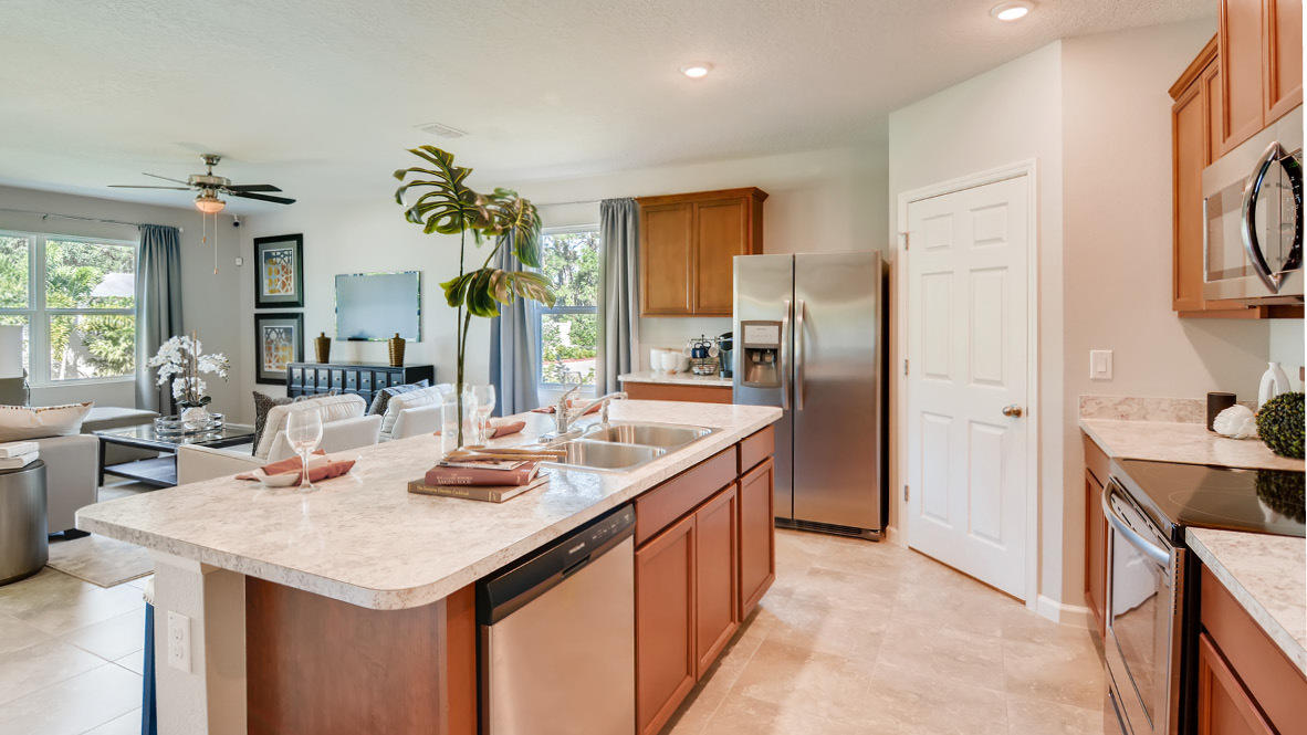 3309 Trinity Circle Fort Pierce, FL 34945 - Photo 2 of 19 a kitchen with a sink refrigerator and cabinets