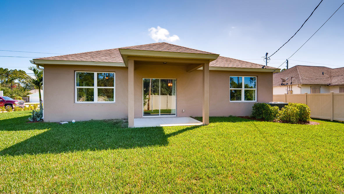 3309 Trinity Circle Fort Pierce, FL 34945 - Photo 10 of 19 a front view of a house with a yard