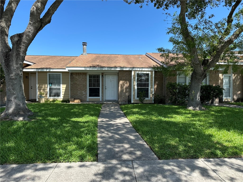 a front view of a house with garden
