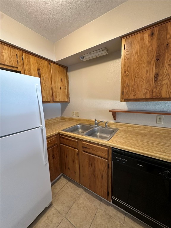 4917 Delwood Street, Unit C3 Corpus Christi, TX 78413 - Photo 12 of 24 a view of a kitchen with a sink and a refrigerator