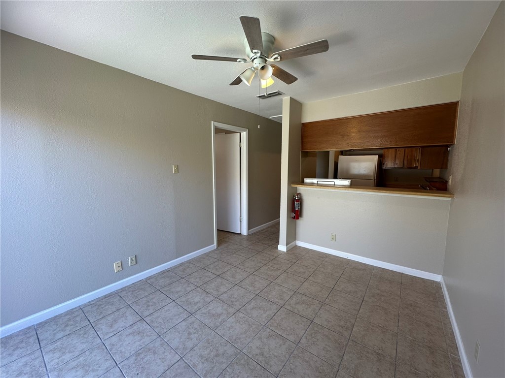 4917 Delwood Street, Unit C3 Corpus Christi, TX 78413 - Photo 15 of 24 a view of an empty room with a ceiling fan