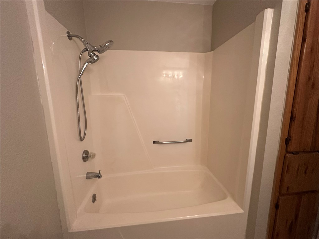 4917 Delwood Street, Unit C3 Corpus Christi, TX 78413 - Photo 19 of 24 a bathroom with a shower and a bath tub