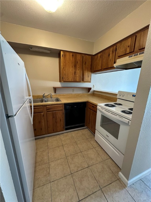 4917 Delwood Street, Unit C3 Corpus Christi, TX 78413 - Photo 10 of 24 a kitchen with stainless steel appliances a stove a sink and a refrigerator