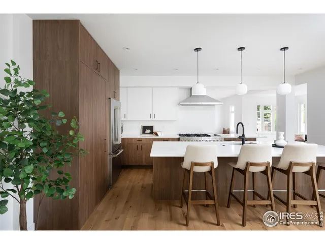 a dining room with furniture window and wooden floor