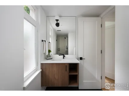 a view of a bathroom with sink and mirror