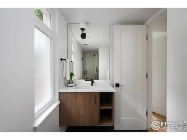 a view of a bathroom with sink and mirror