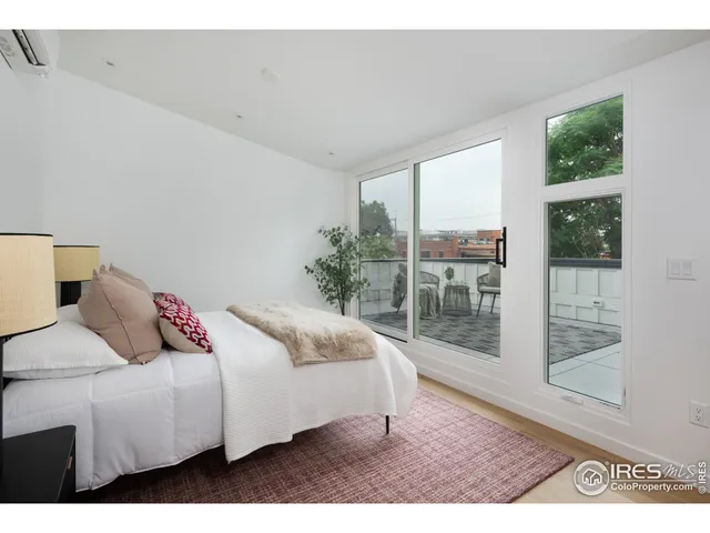 a bedroom with a bed lamp and window