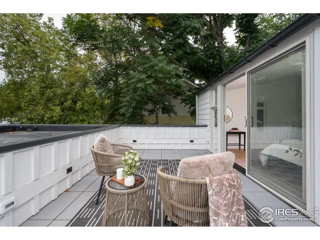 a view of balcony with furniture and garden