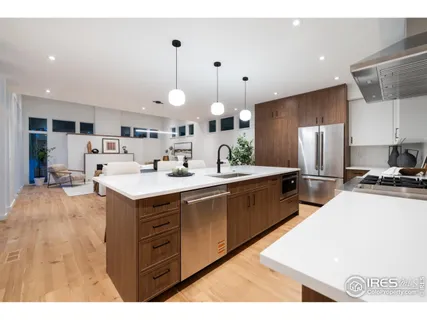 a large kitchen with kitchen island a sink a counter top space stainless steel appliances and a center island