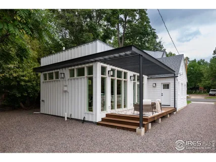a backyard of a house with table and chairs