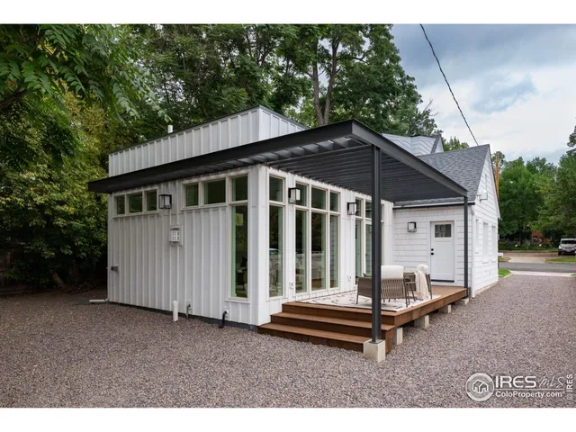 a backyard of a house with table and chairs