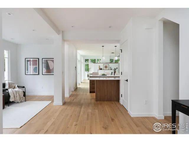 a open kitchen with cabinets wooden floor and stainless steel appliances