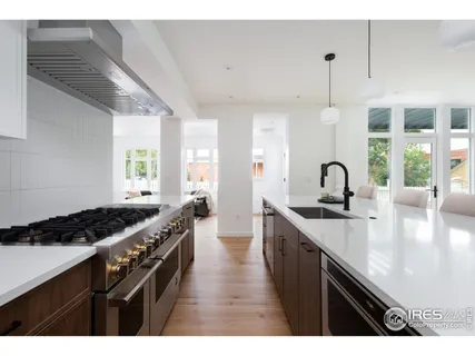 a kitchen with sink stove and cabinets