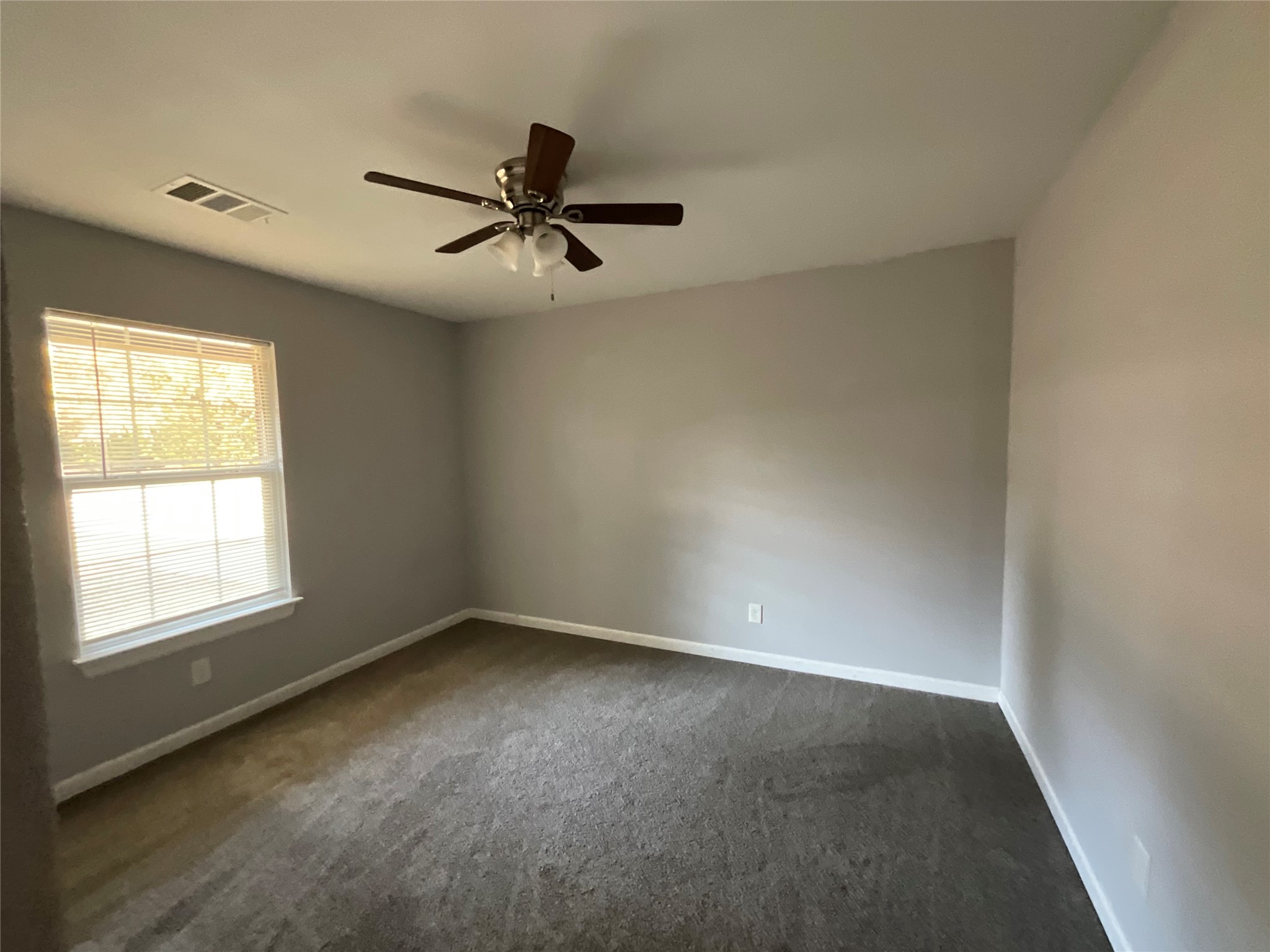 239 Old Firetower Road Bastrop, TX 78602 - Photo 35 of 39 Empty room with dark carpet and a ceiling fan