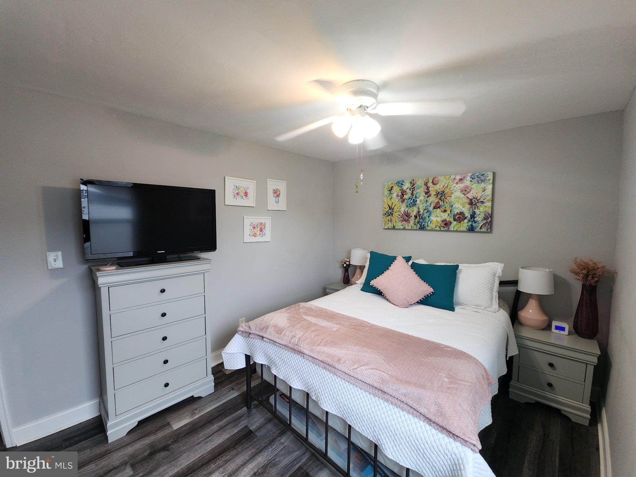 802 Devon Road Riverside, NJ 08075 - Photo 15 of 29 a bedroom with a large bed and a flat screen tv