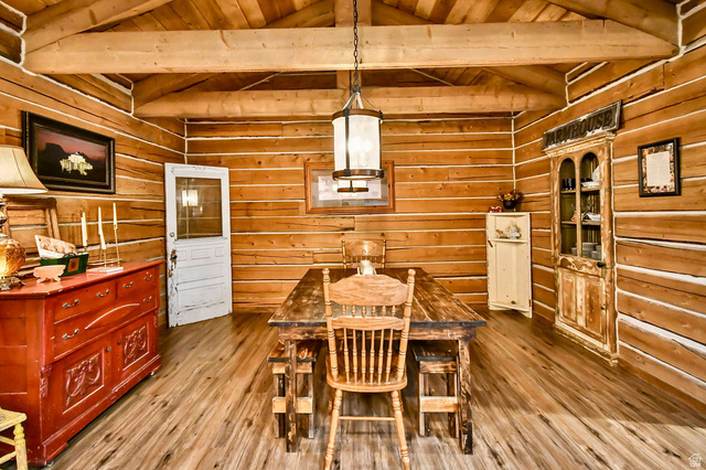 544 East 600 North, Unit 1 Joseph, UT 84739 - Photo 14 of 65 Interior space featuring wood-finish flooring, exposed wood beam ceiling, wood plank walls, and a prominent central chandelier
