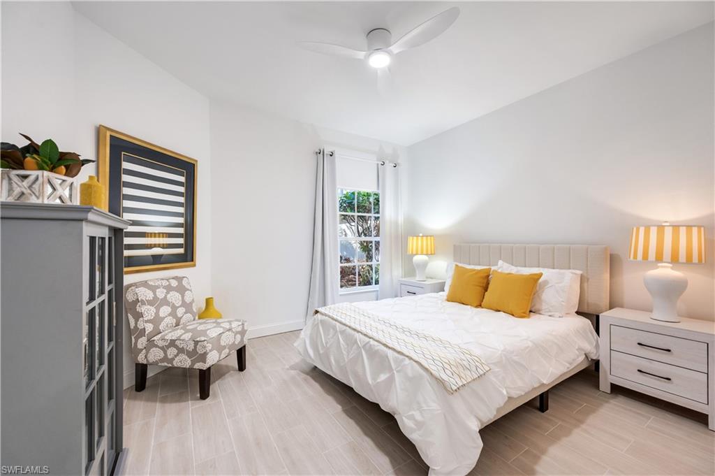 2806 Aintree Lane, Unit H102 Naples, FL 34112 - Photo 16 of 26 Bedroom featuring wood tiled floors and a ceiling fan