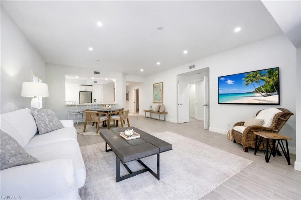 Living area with wood tiled floors and recessed lighting