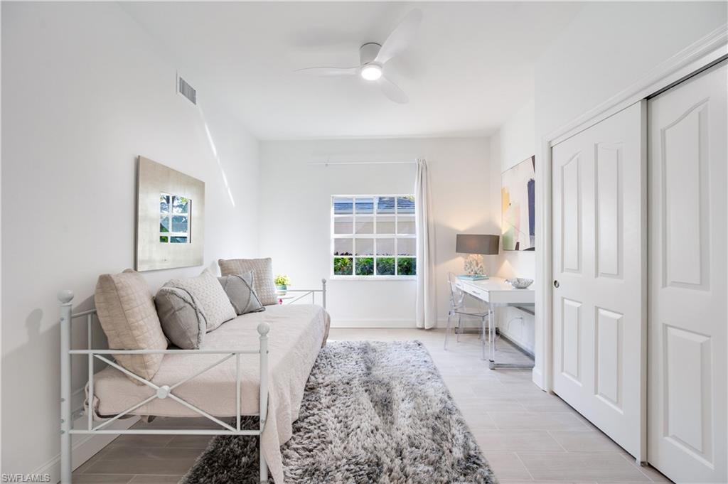 2806 Aintree Lane, Unit H102 Naples, FL 34112 - Photo 19 of 26 Living area featuring ceiling fan and wood finish floors