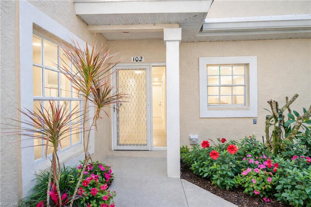 2806 Aintree Lane, Unit H102 Naples, FL 34112 - Photo 21 of 26 Property entrance with stucco siding