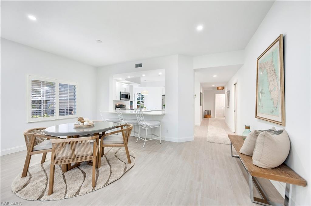 2806 Aintree Lane, Unit H102 Naples, FL 34112 - Photo 8 of 26 Dining space featuring light wood-style floors, recessed lighting, and healthy amount of natural light