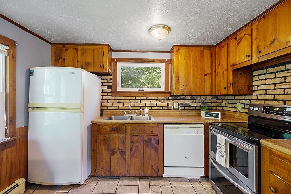 75 Main Road Phillipston, MA 01436 - Photo 10 of 27 a kitchen with a refrigerator and a stove