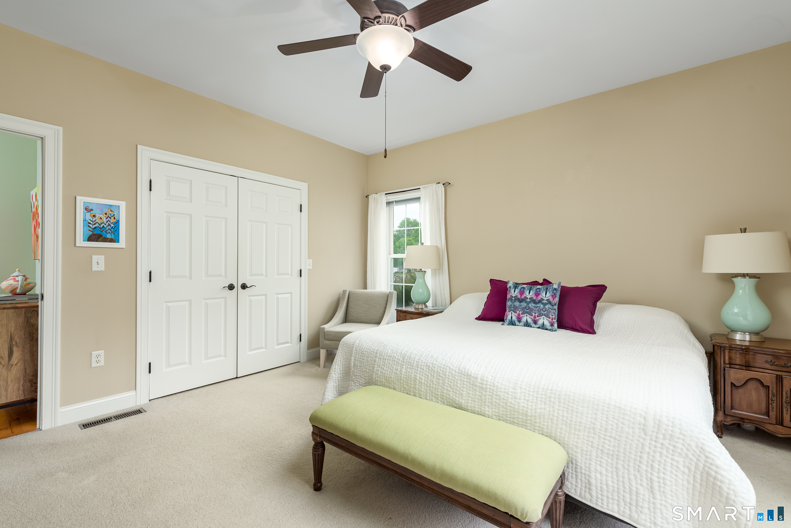 8 Greendale Drive, Unit 8 Suffield, CT 06078 - Photo 26 of 40 a bedroom with a bed and a chandelier
