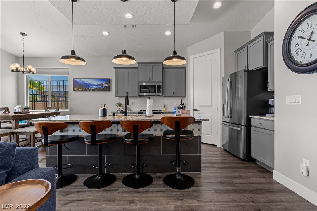 1436 Manassas Ridge Mesquite, NV 89027 - Photo 26 of 77 A contemporary kitchen space boasts an inviting island with pendant lighting and views to the dining area.