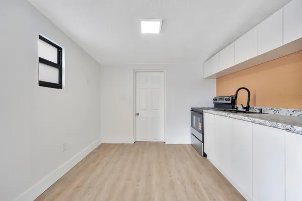 a kitchen with a sink and a hard wood floor