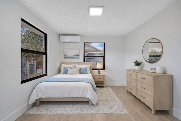 a bedroom with a large bed and a dresser