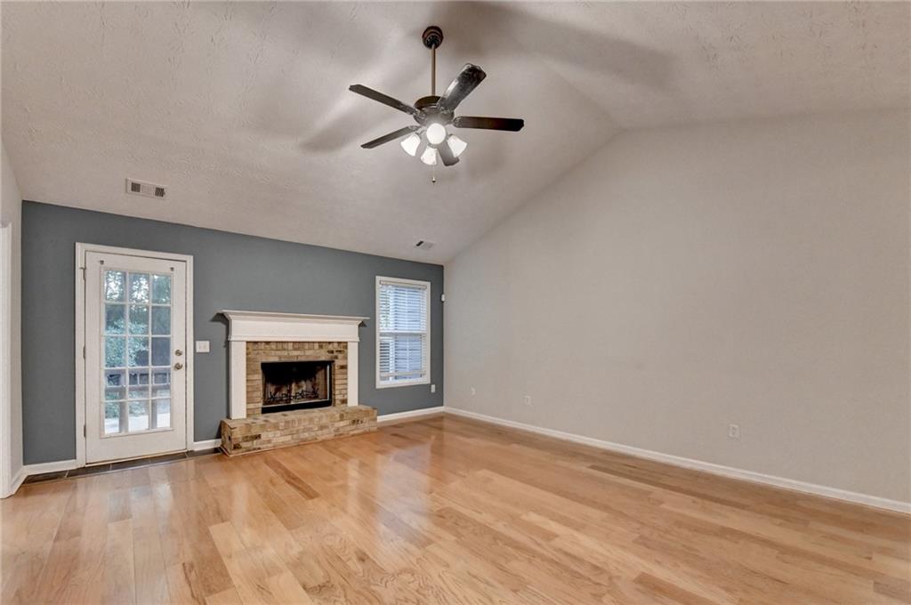 310 Andrew Ridge Drive Jefferson, GA 30549 - Photo 9 of 52 a view of empty room with fireplace and wooden floor