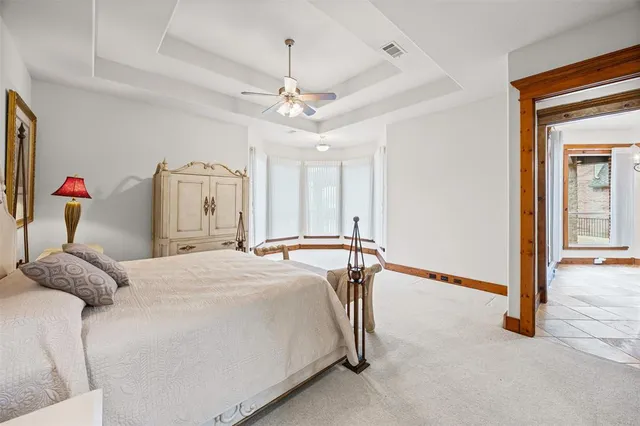 a bedroom with a bed and ceiling fan