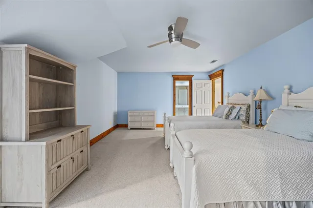 a bed room with a bed and a book shelf
