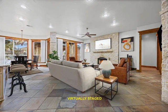 a living room with furniture and large windows