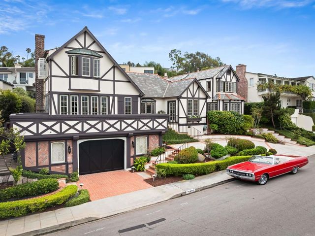 a dining room with stainless steel appliances granite countertop furniture and a large window
