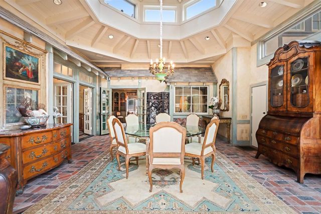 a backyard of a house with large trees and plants