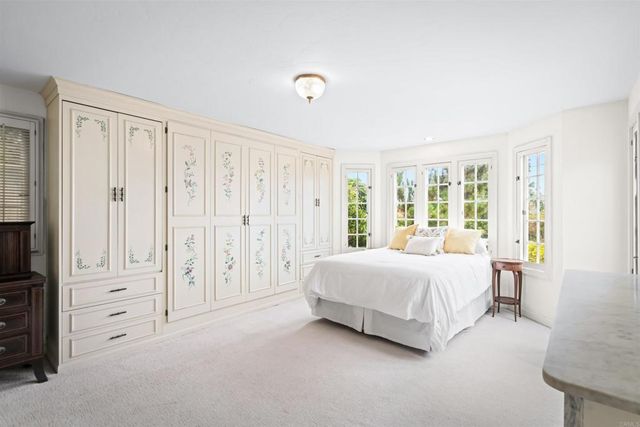 a spacious bedroom with a bed and a table