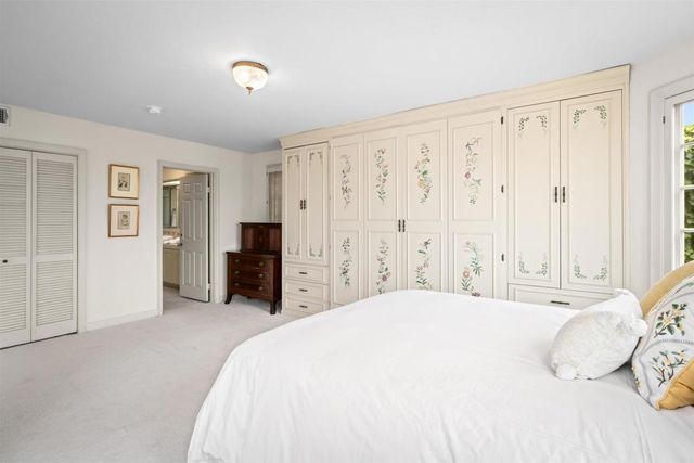 a spacious bedroom with a balcony a bed and a fireplace