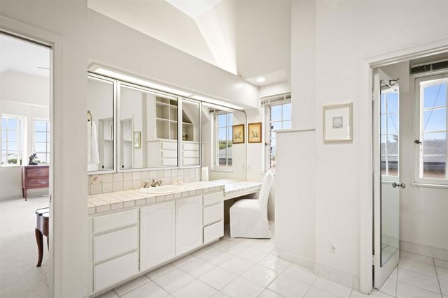 a front view of a house with a garden and plants