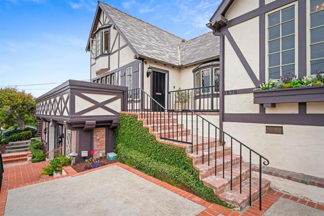 a view of a bedroom with a bed and a window