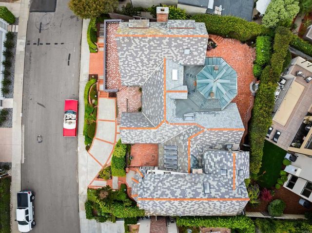 a front view of a house with a garden and parking