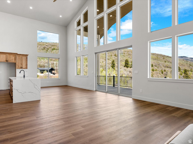 1159 North Broad Hollow Road Garden City, UT 84028 - Photo 26 of 55 Expansive interior space featuring a vaulted ceiling and numerous floor-to-ceiling windows