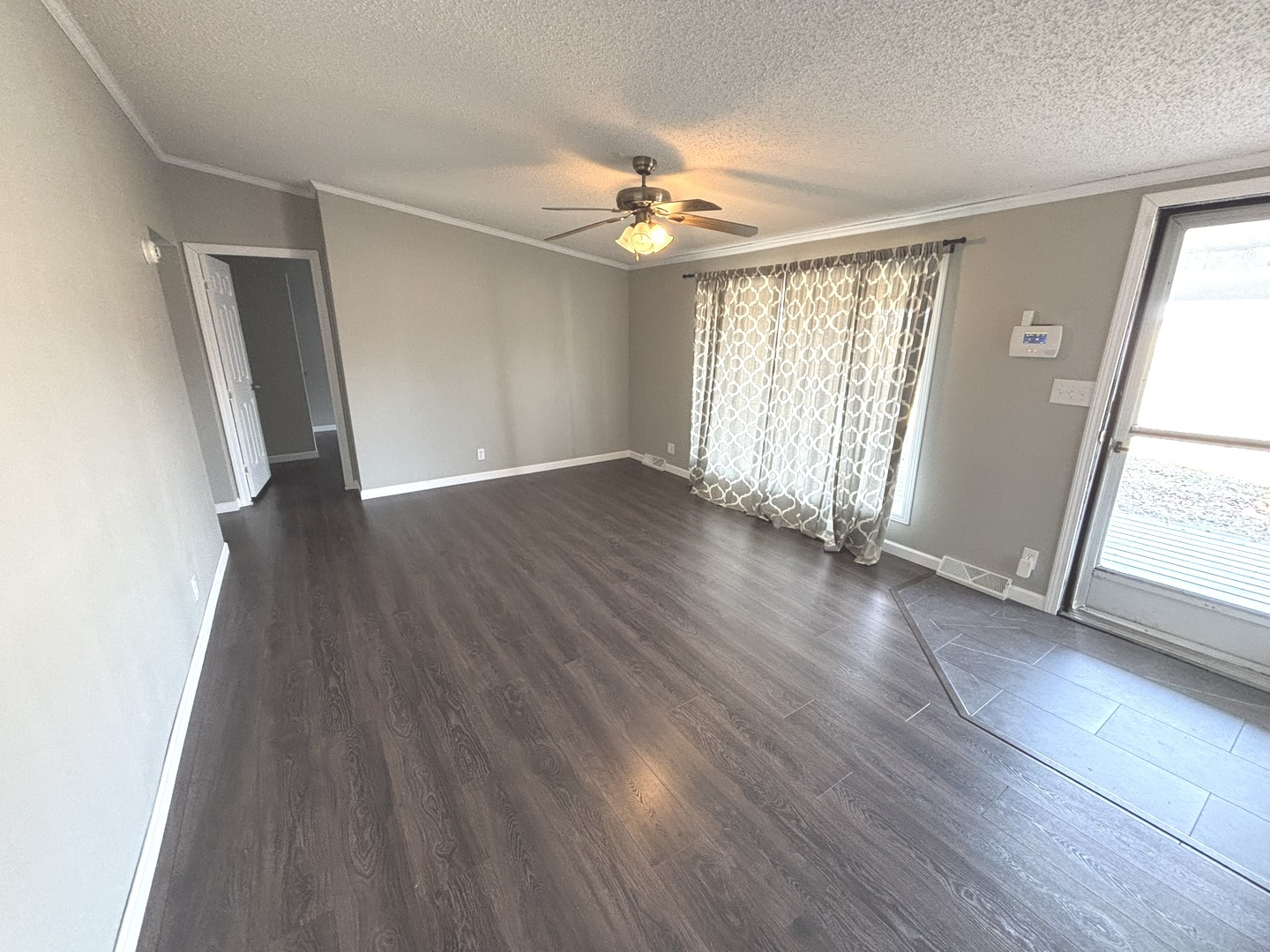 4120 Bannister Road Salem, IL 62881 - Photo 2 of 20 an empty room with wooden floor and windows