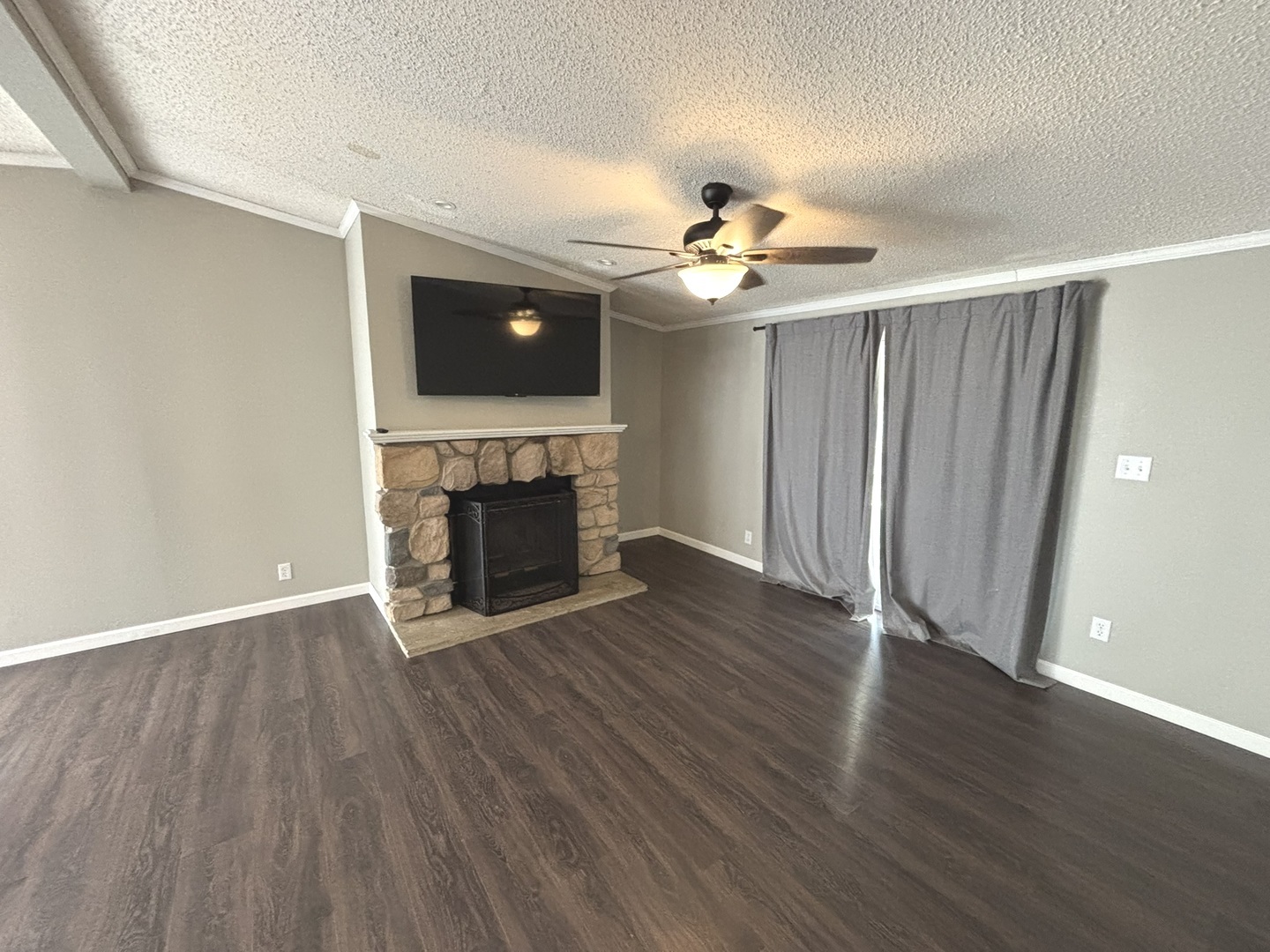 4120 Bannister Road Salem, IL 62881 - Photo 9 of 20 an empty room with wooden floor fireplace and a window