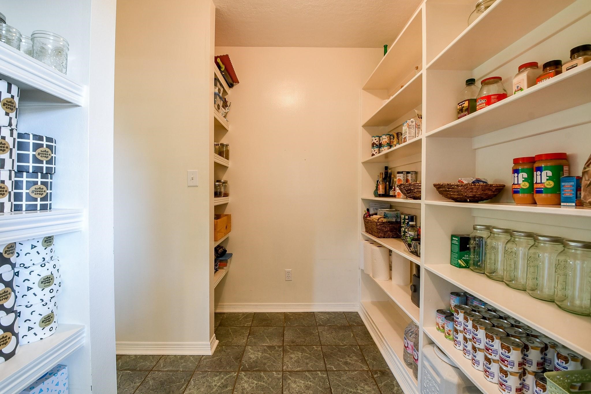 22035 Buescher Road Tomball, TX 77377 - Photo 20 of 44 a view of walk in closet with clothes and shoes
